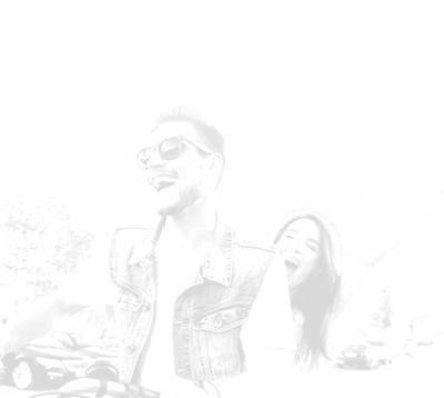 two people smiling while riding a motorcycle