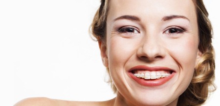 an adult woman with braces smiling